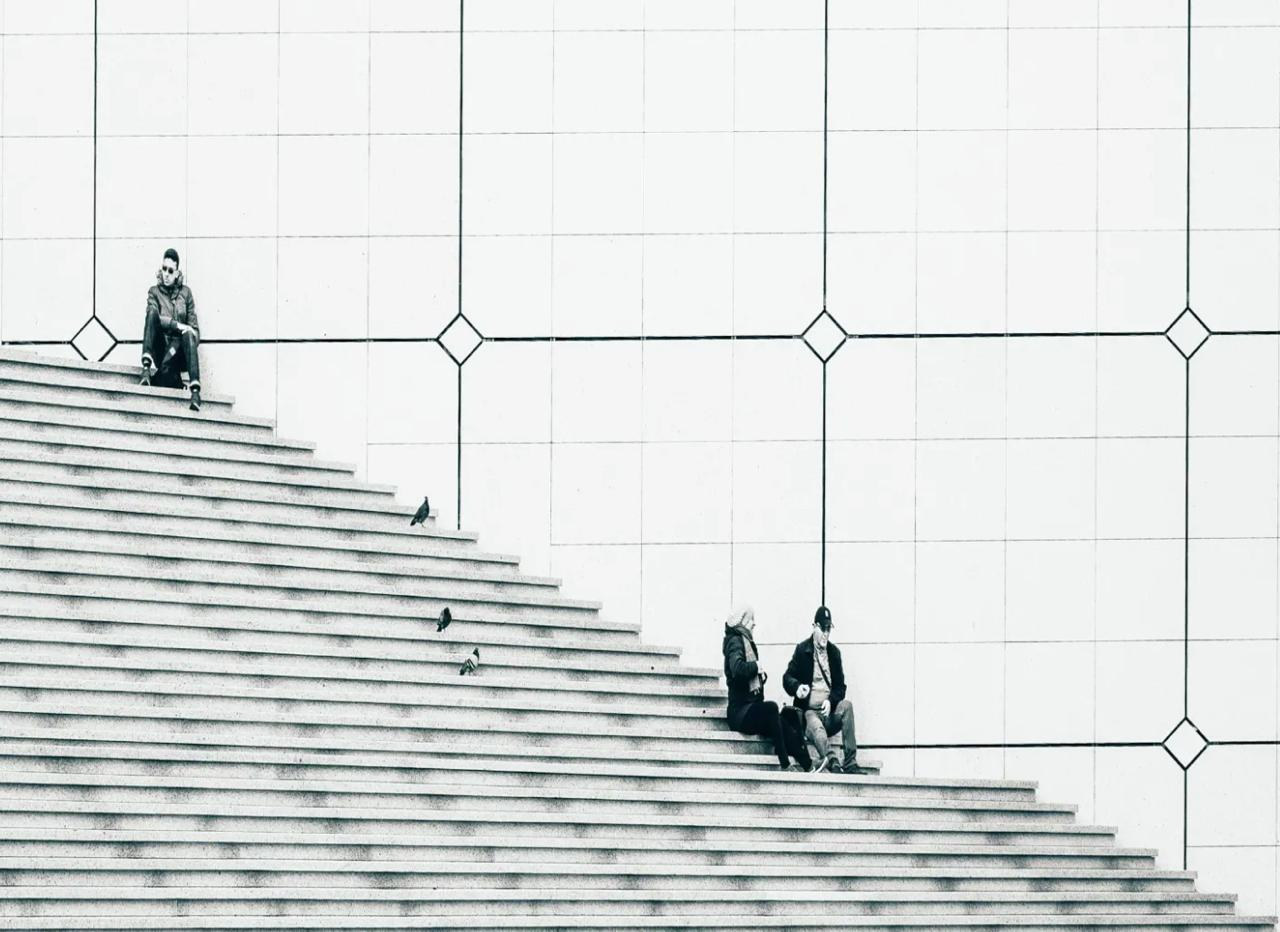 People sitting on wide white architectural steps